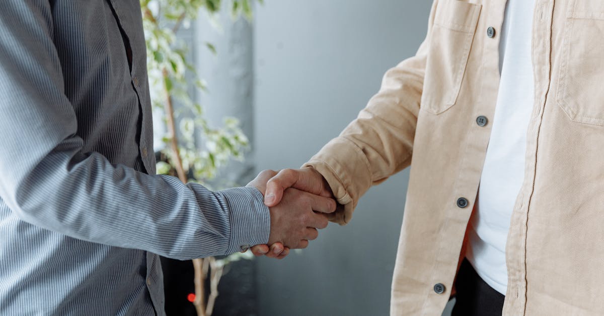 A close-up image of two businesspeople shaking hands in an office environment symbolizing agreement and partnership.